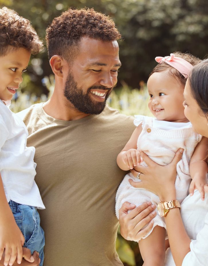 Black family, happy and nature park with people holding a child and baby outdoor. Mother, father and children together in the summer sun with happiness smile and kids spending quality time outdoors Black family, happy and nature park with people holding a child and baby outdoor. Mother, father and children together in the summer sun with happiness smile and kids spending quality time outdoors.