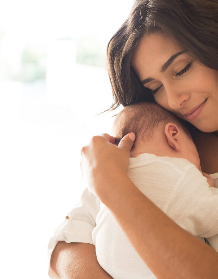 Woman with newborn baby Pretty woman holding a newborn baby in her arms